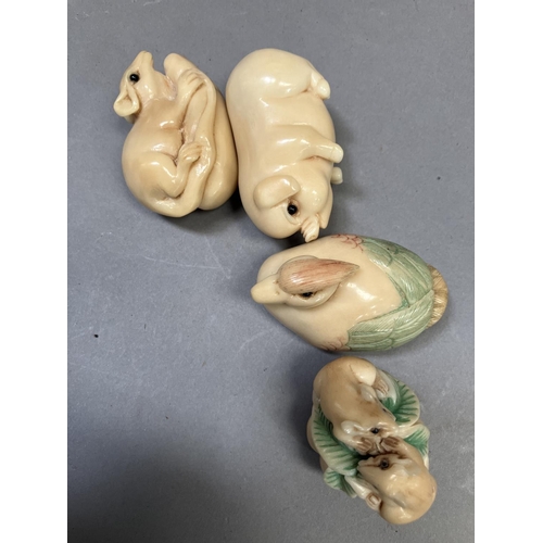 223 - Four modern Japanese netsuke figures, formed as a Mandarin signed to base, a pig, a mouse on a nut s... 