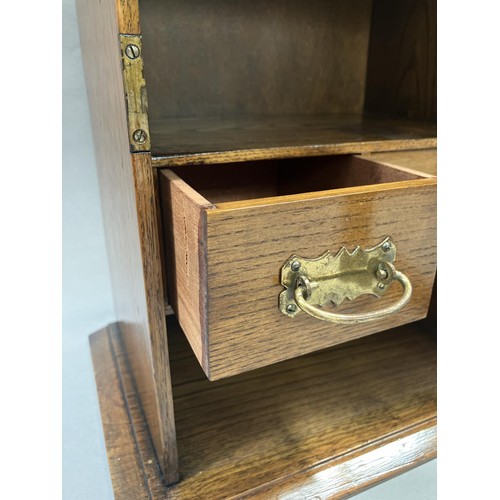 215 - An oak smokers cabinet with glazed door, fitted interior with two drawers