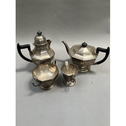 246 - A George VI four piece silver tea service of octagonal outline, on pedestal foot, ebonised handles c... 