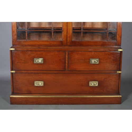 94 - Kennedy of Ipswich, a walnut and brass bound campaign bookcase-chest retailed by Harrods, having two... 