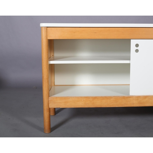 119 - A beech and white sideboard, having two sliding doors, fitted with one shelf, on rounded legs, 151cm... 