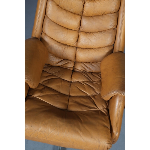 28 - A tan leather upholstered swivel chair, on five spoke base, c1960/70s