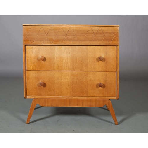 113 - An oak and walnut veneered chest of drawers c1960s, having a frieze drawer with incised running wave... 