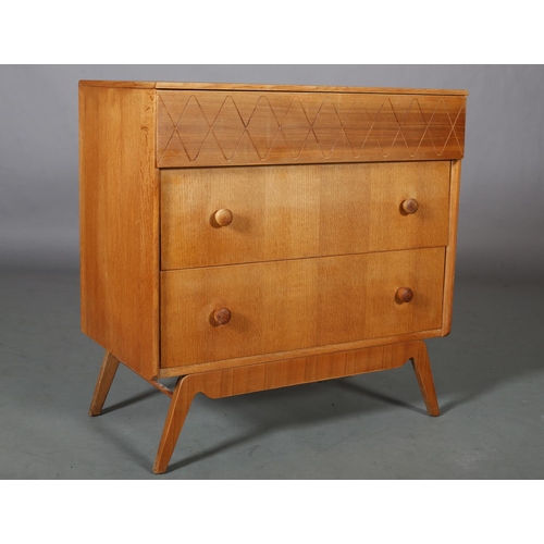 113 - An oak and walnut veneered chest of drawers c1960s, having a frieze drawer with incised running wave... 