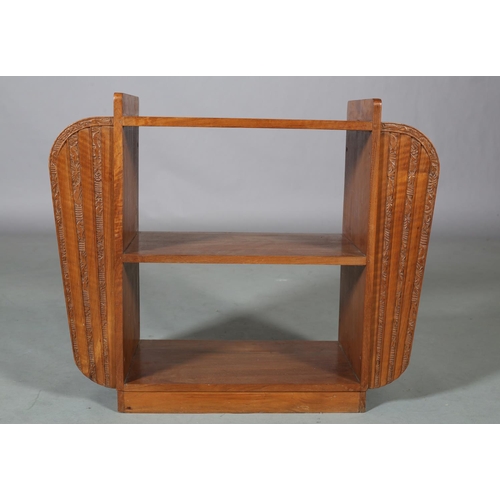 108 - An Art Deco satin walnut and walnut open bookstand with side magazine racks, carved vertical bands o... 