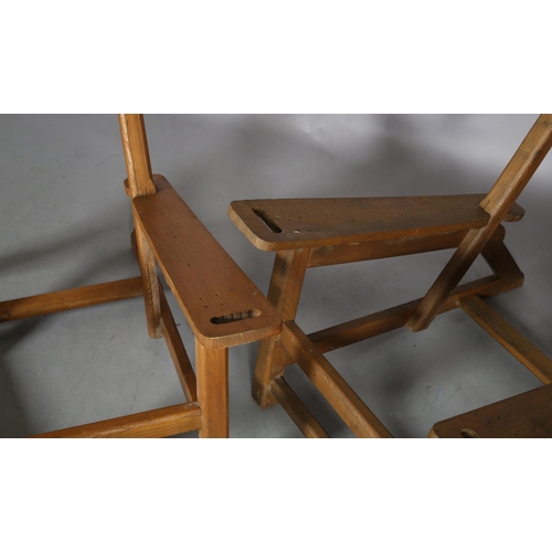 131 - A pair of elm armchair frames, c1940s, low rectangular back, broad tapered arms with finger grip, on... 