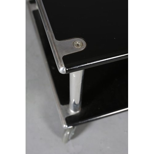 26 - A chrome and black two tier stand or table, rectangular, on castors, 60cm wide x 50cm deep x 38cm hi... 