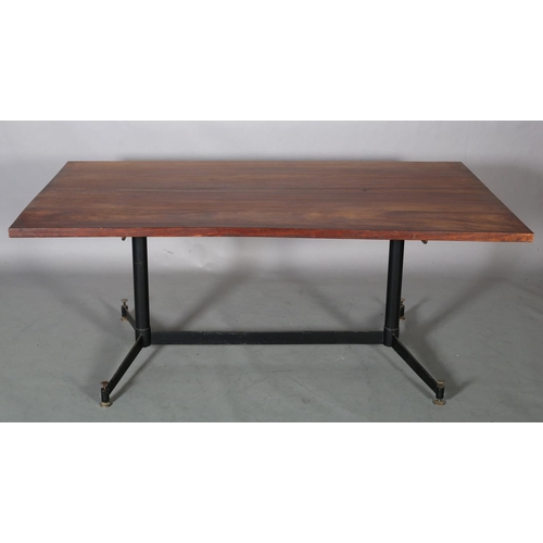 60 - An Italian walnut dining table c1960s on metal twin pedestal joined by a stretcher and on splayed fe... 