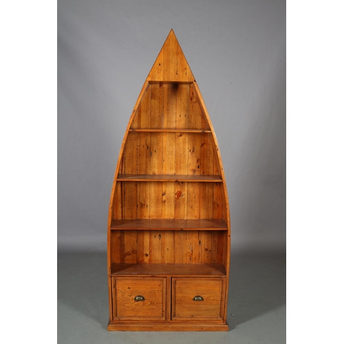 96 - A set of pine boat-shaped bookshelves above two indented panel drawers with brass cup handles, on pl... 