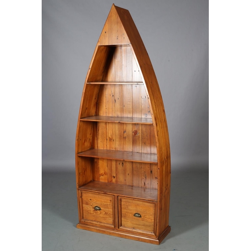 96 - A set of pine boat-shaped bookshelves above two indented panel drawers with brass cup handles, on pl... 