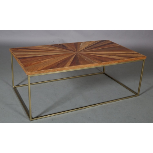 61 - A coffee table, the surface of radiating veneers of wood specimens, on a pale gilt metal frame, 122c... 