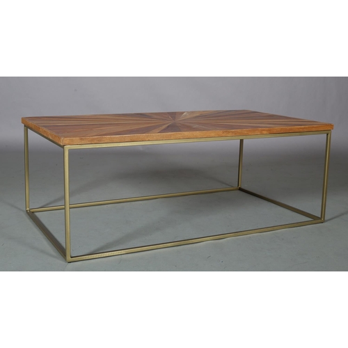 61 - A coffee table, the surface of radiating veneers of wood specimens, on a pale gilt metal frame, 122c... 