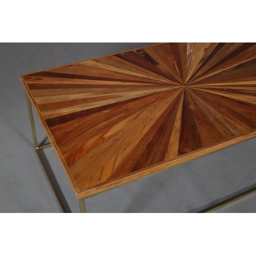 61 - A coffee table, the surface of radiating veneers of wood specimens, on a pale gilt metal frame, 122c... 