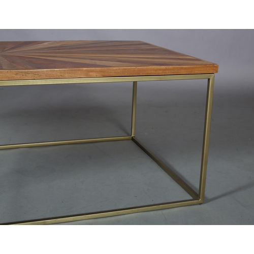 61 - A coffee table, the surface of radiating veneers of wood specimens, on a pale gilt metal frame, 122c... 