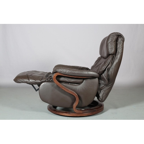 31 - A Himolla brown leather reclining swivel armchair on bentwood frame