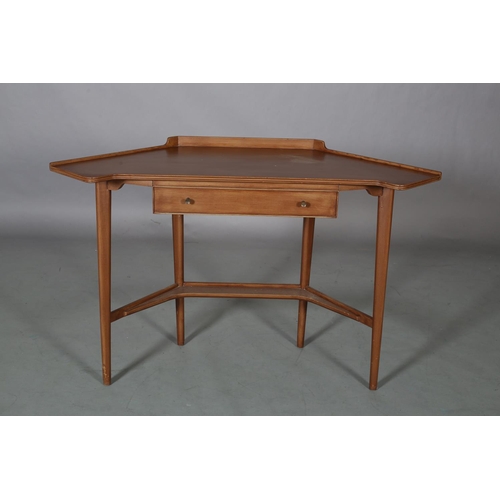 62 - A mahogany finish corner writing table, with gallery, drawer to apron, on rounded and tapered legs a... 