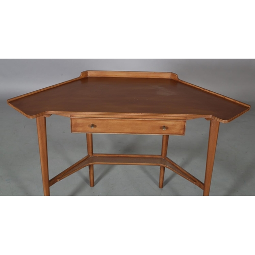 62 - A mahogany finish corner writing table, with gallery, drawer to apron, on rounded and tapered legs a... 