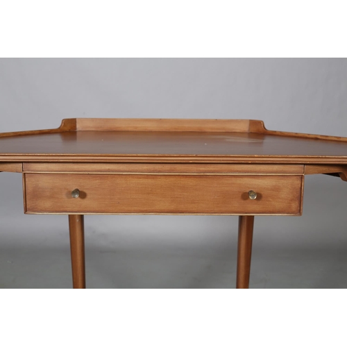 62 - A mahogany finish corner writing table, with gallery, drawer to apron, on rounded and tapered legs a... 