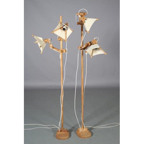 33 - A pair of Spanish pine floor lamps, each with two adjustable arms, 163.5cm high