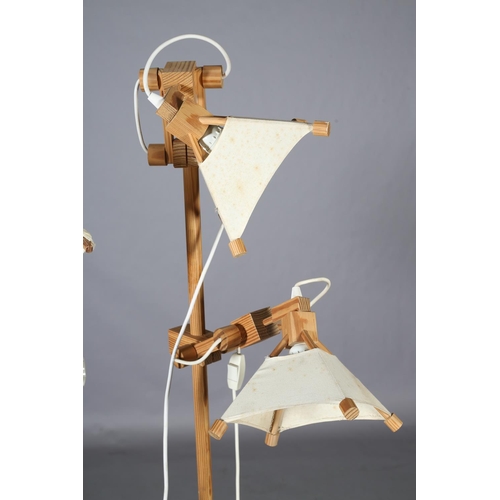 33 - A pair of Spanish pine floor lamps, each with two adjustable arms, 163.5cm high