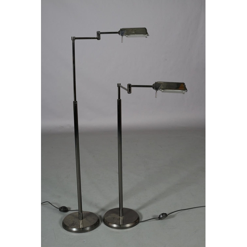 85 - A pair of French patinated nickel floor lamps with articulating heads, on telescopic columns, on cir... 