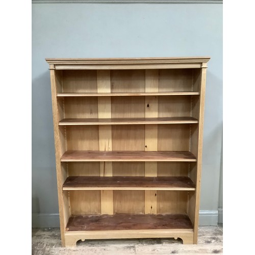 291 - An oak open bookcase having a moulded cornice above four adjustable shelves, on bracket feet, 120cm ... 