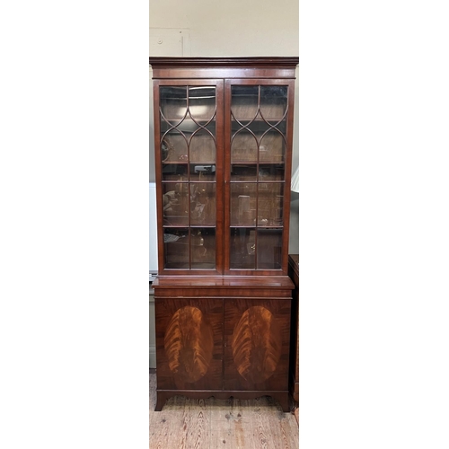 264 - A Sheraton style mahogany bookcase cabinet, moulded cornice above two tracery glazed doors, a two do... 