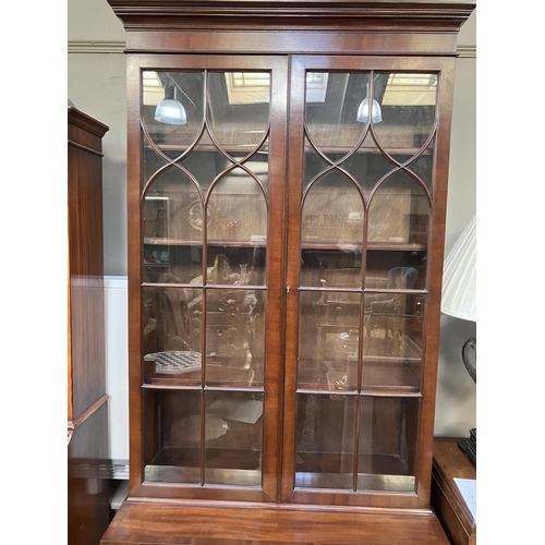 264 - A Sheraton style mahogany bookcase cabinet, moulded cornice above two tracery glazed doors, a two do... 