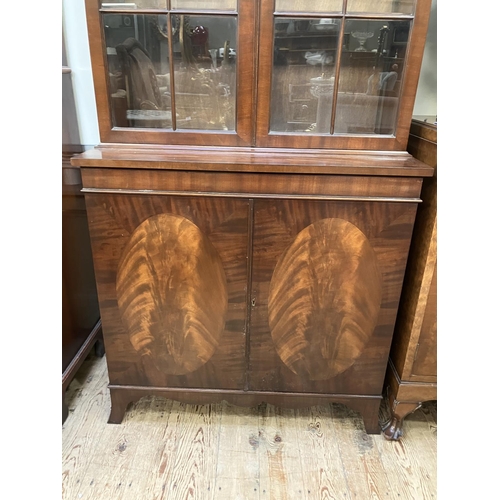 264 - A Sheraton style mahogany bookcase cabinet, moulded cornice above two tracery glazed doors, a two do... 