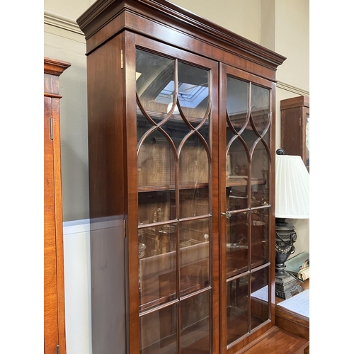 264 - A Sheraton style mahogany bookcase cabinet, moulded cornice above two tracery glazed doors, a two do... 