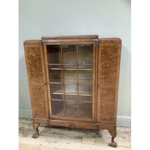 266 - A mid 20th Century walnut cabinet having a glaze door to the centre fitted with three internal shelv... 