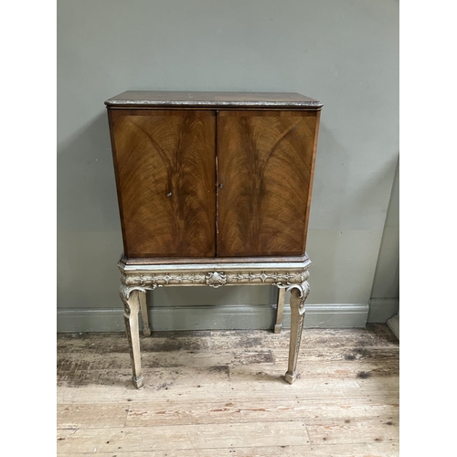 290 - A mid 20th Century walnut and silverwood drinks cabinet by Robson & Sons Ltd, having two door, fitte... 