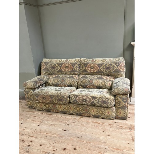 281 - A three seater sofa with two armchairs upholstered in Aztec style fabric