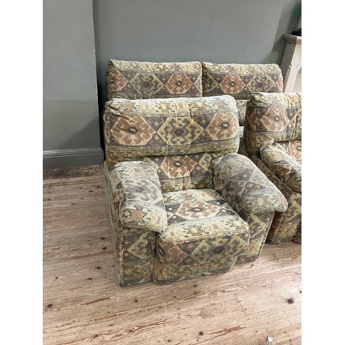 281 - A three seater sofa with two armchairs upholstered in Aztec style fabric