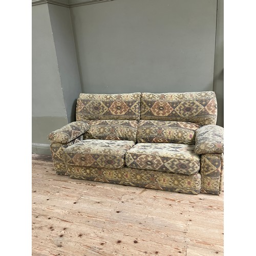 281 - A three seater sofa with two armchairs upholstered in Aztec style fabric