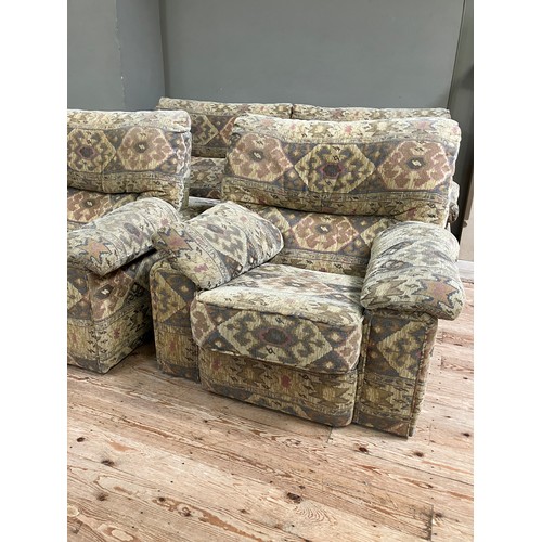 281 - A three seater sofa with two armchairs upholstered in Aztec style fabric