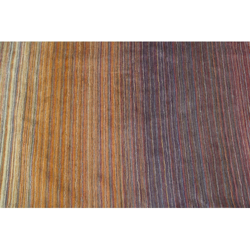 120 - Conran, A multi-coloured striped wool rug, in muted shades, 243cm x 172cm