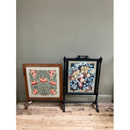 327 - A yew wood framed fire screen inset with an Arts and Craft style floral tapestry, 69cm wide x 85cm h... 