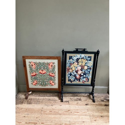 327 - A yew wood framed fire screen inset with an Arts and Craft style floral tapestry, 69cm wide x 85cm h... 