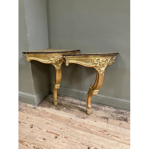 313 - A pair of 18th Century style gilt wood  corner console tables with fabric lined surfaces