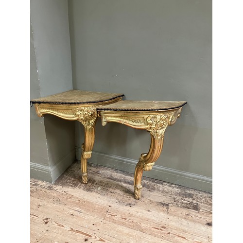 313 - A pair of 18th Century style gilt wood  corner console tables with fabric lined surfaces