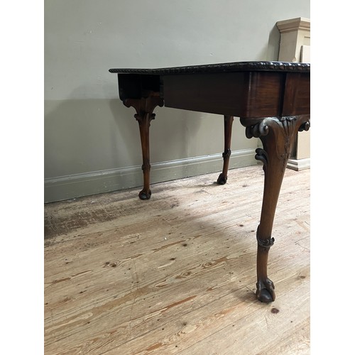 346 - A 19th century Irish mahogany fold over dining table by R Strahan and Co, having carved edge and fol... 