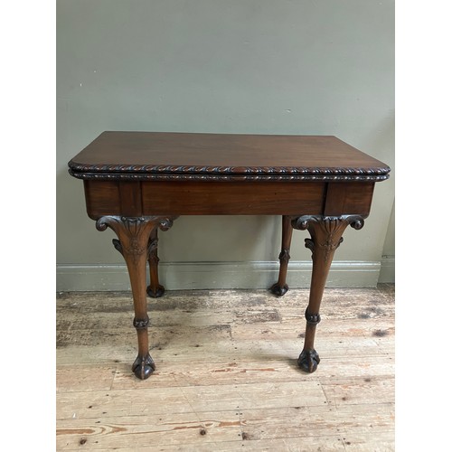 346 - A 19th century Irish mahogany fold over dining table by R Strahan and Co, having carved edge and fol... 