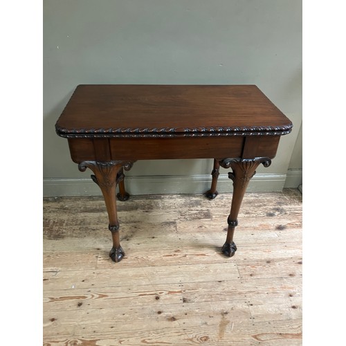 346 - A 19th century Irish mahogany fold over dining table by R Strahan and Co, having carved edge and fol... 