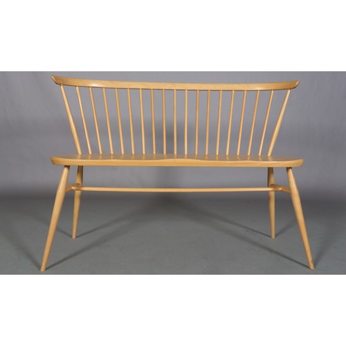 40 - An Ercol 'Originals' blonde love seat, with stick back, decal to underside, 112cm wide, 82cm high an... 