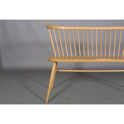 40 - An Ercol 'Originals' blonde love seat, with stick back, decal to underside, 112cm wide, 82cm high an... 