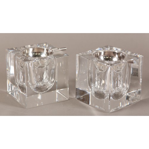 51 - Ercuis, France, A pair of clear ashtrays of cuboid form with silver plated dished liners, 9cm