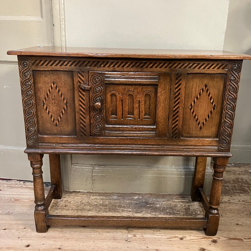 301 - A reproduction Titchmarsh and Goodwin style oak cabinet having one door to the front, on square fram... 