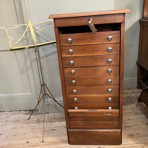 342 - A 20th century beech and mahogany music cabinet with tambour front and on plinth base, 50.5cm wide, ... 