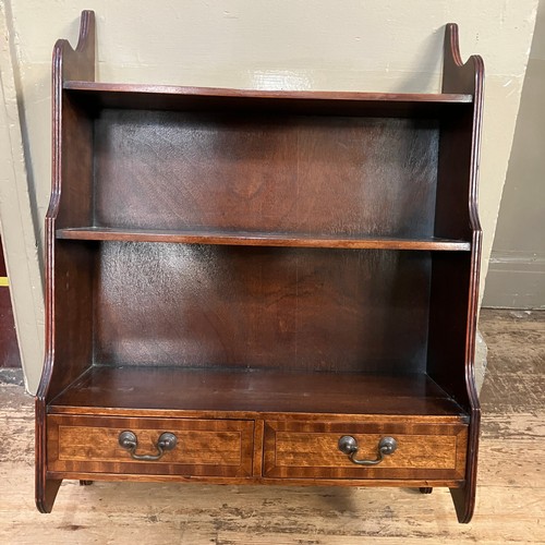 347 - A mahogany open bookcase with three graduated shelves above two short drawers, 57cm wide x 76cm high